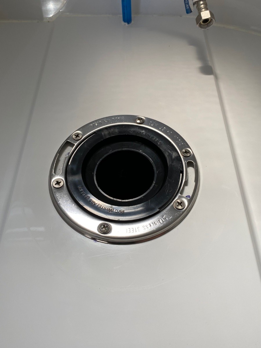 Upgraded toilet flange with a stainless steel ring for enhanced durability, replacing the cracked plastic flange and ensuring a better travel trailer toilet seal.