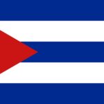 Cuban flag waving proudly against a blue sky