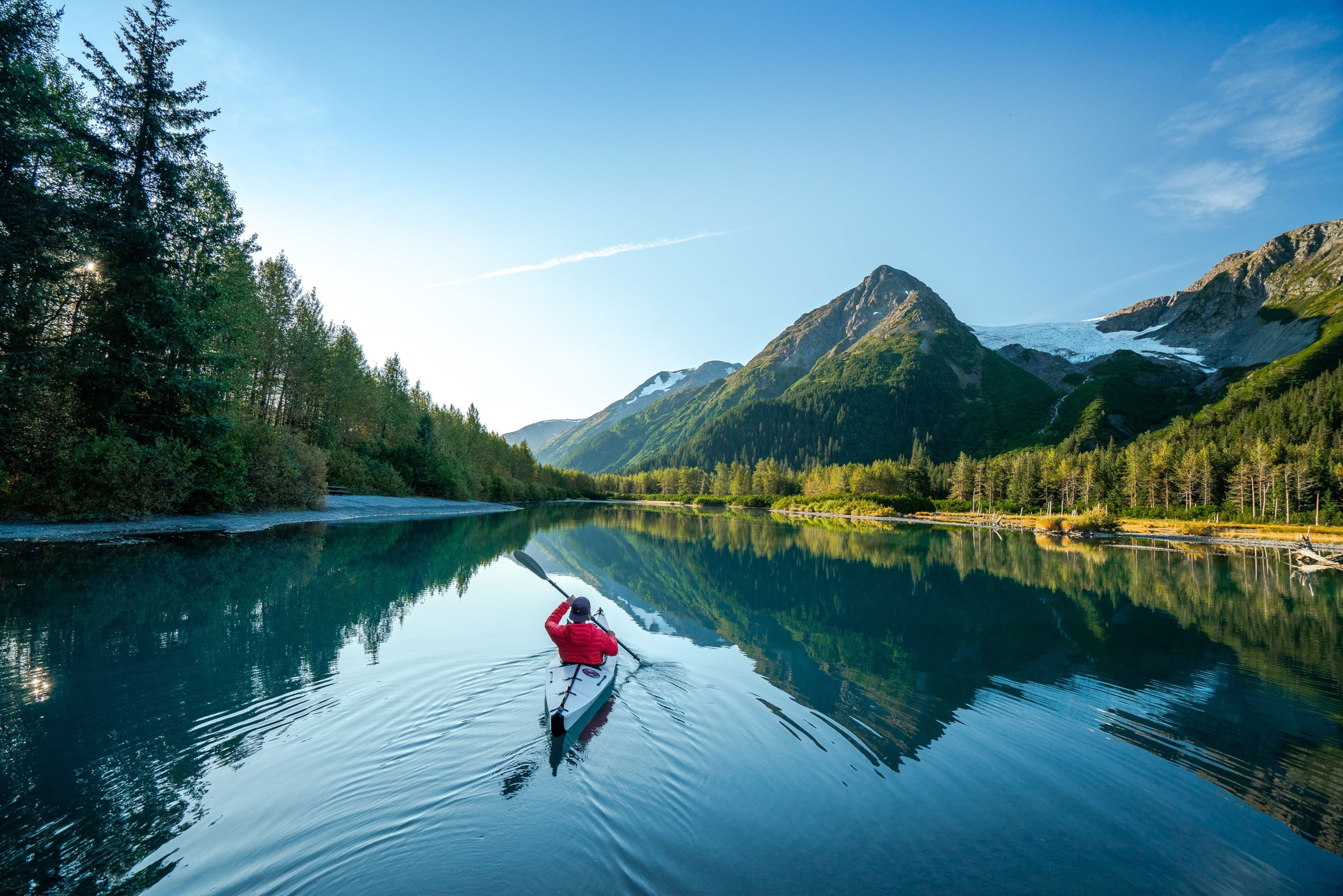 A kayaker paddles a pristine river in Alaska. The state’s remoteness offers plenty of space for wildlife viewing.