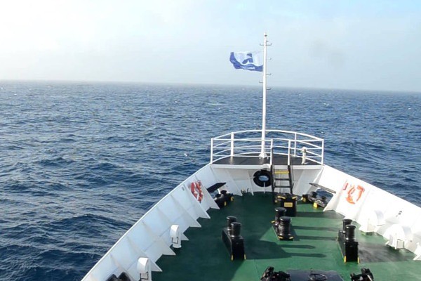 Image depicting a cruise ship sailing in calm Antarctic waters, contrasting with the rough Drake Passage, suitable for illustrating fly-cruise benefits