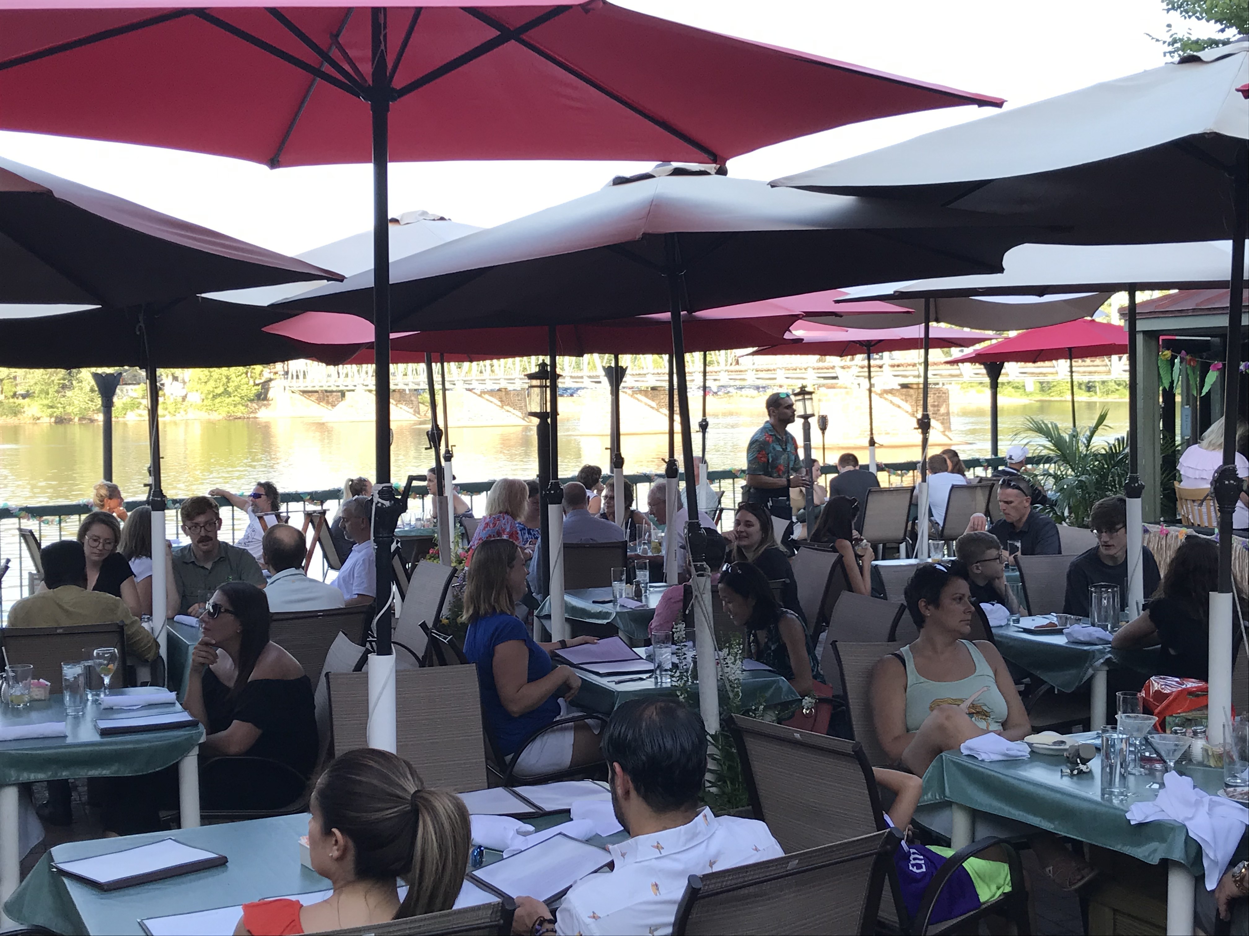 Outdoor patio seating at The Landing restaurant in New Hope, PA, along the river