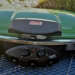 Our previous Coleman two-burner grill has a built-in grill stand and tray tables.