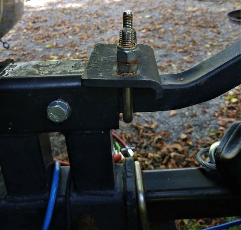 The U-bolt and plate solution used to stabilize the old bike rack and hitch receiver connection.