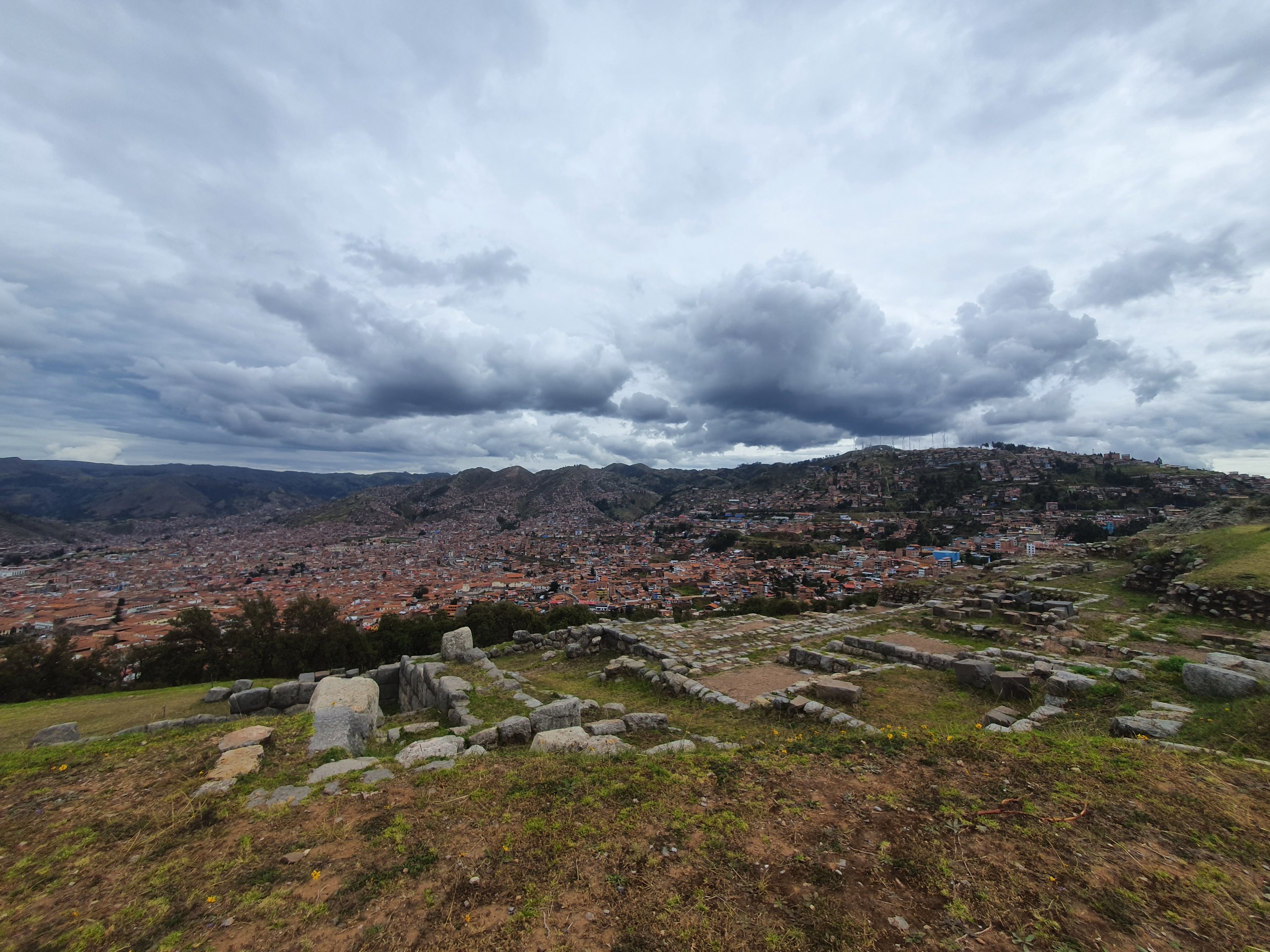 View of Cusco city from the heights of Saqsaywaman, showcasing the blend of Inca and colonial architecture.