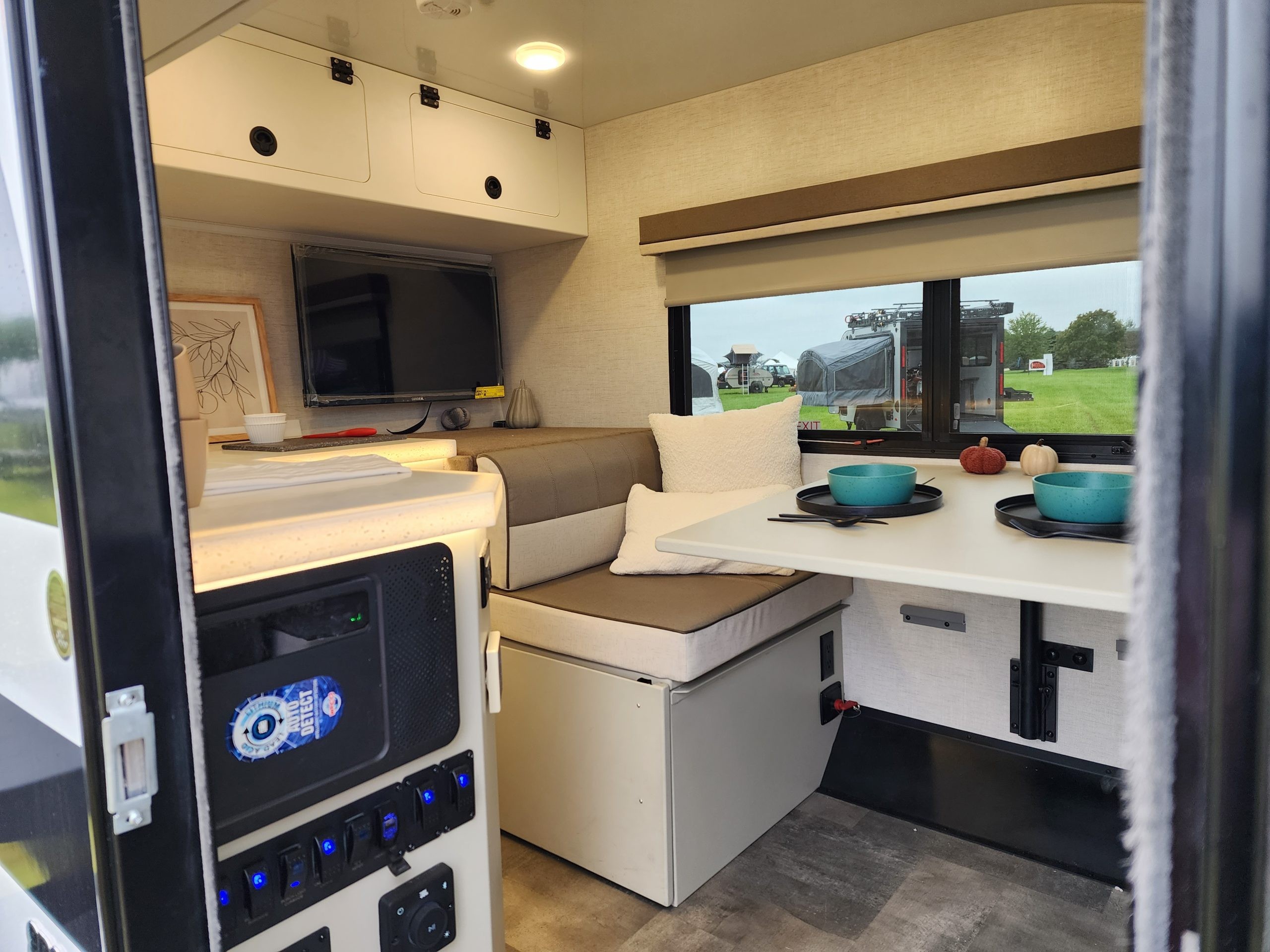 Interior view of the Encore RV VENŪ 1500 lb travel trailer showing the dinette area before conversion to a bed.