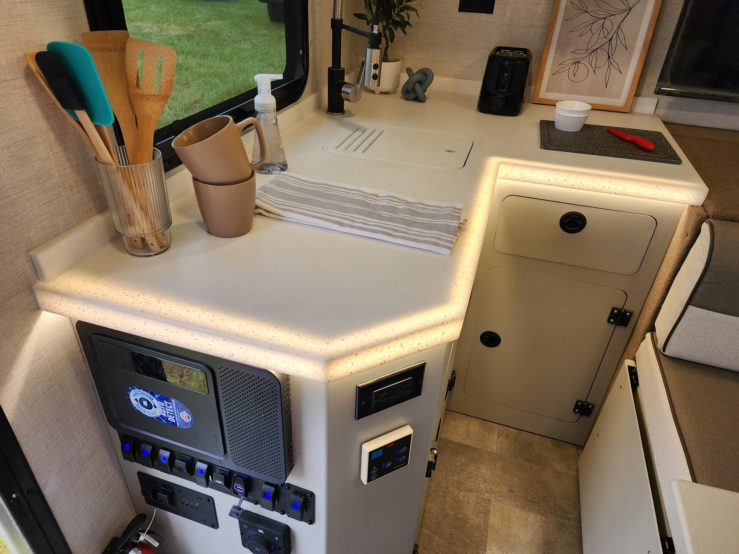 Detail of the kitchen countertop in the Encore RV VENŪ 1500 lb travel trailer, illustrating the available workspace.