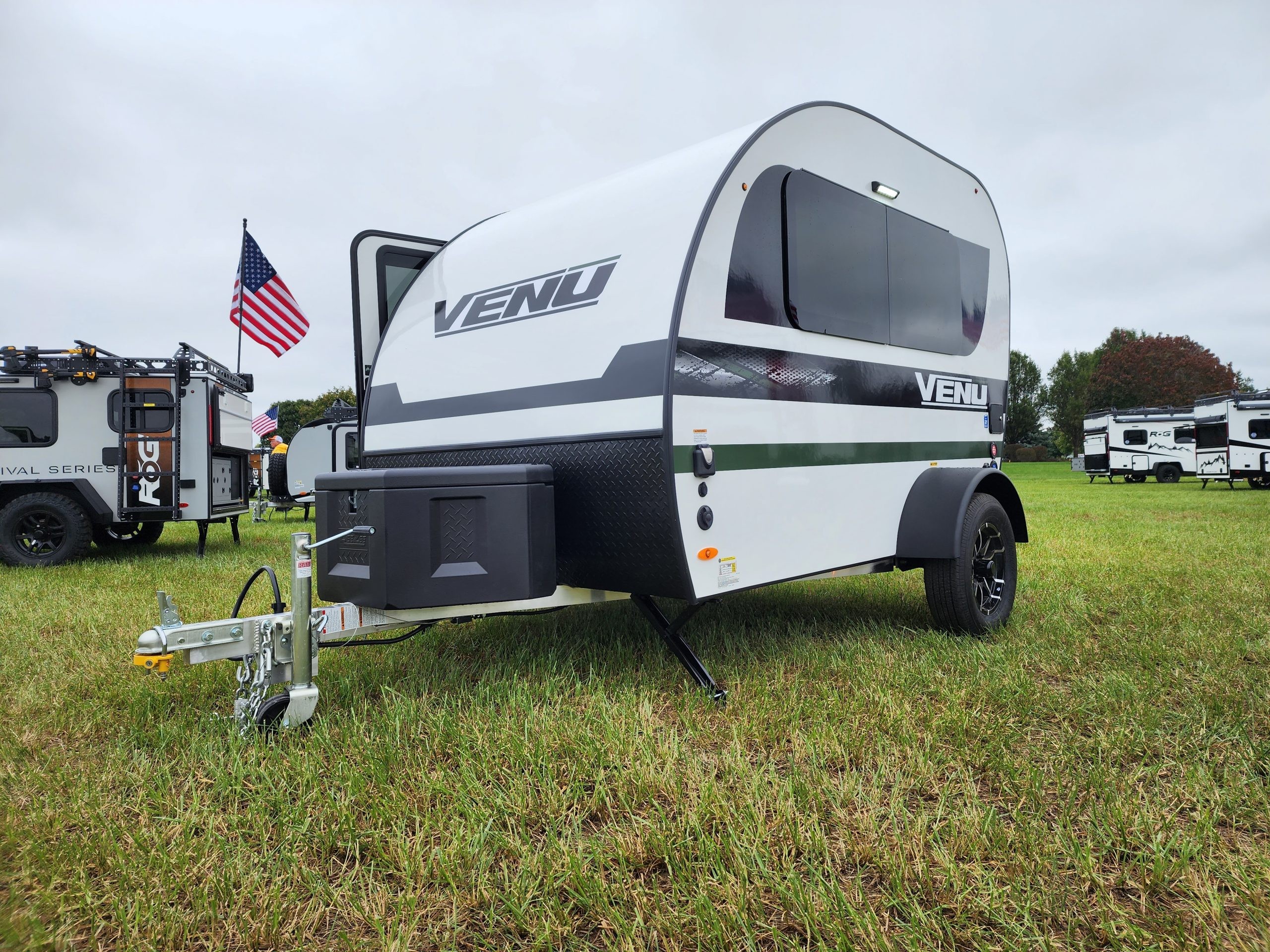 Front view of the Encore RV VENŪ 1500 lb travel trailer highlighting its modern design and compact profile.