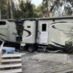 Burnt travel trailer refrigerator in a slide-out, emphasizing the need for regular travel trailer fridge repair and safety checks.