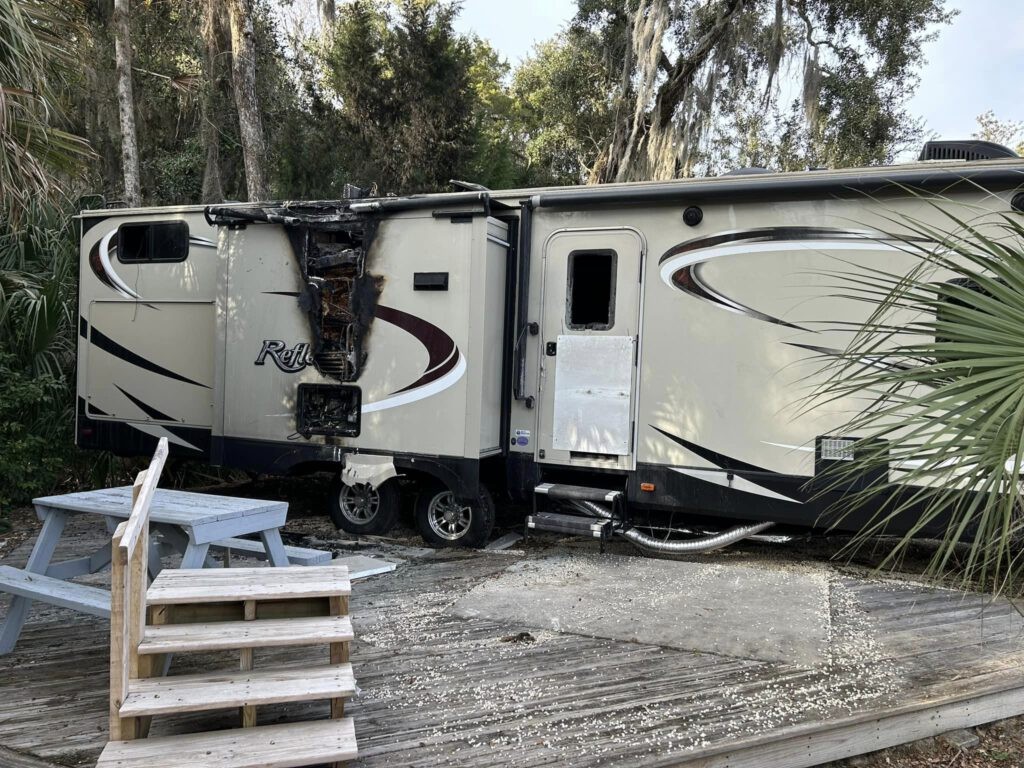 Burnt travel trailer refrigerator in a slide-out, emphasizing the need for regular travel trailer fridge repair and safety checks.