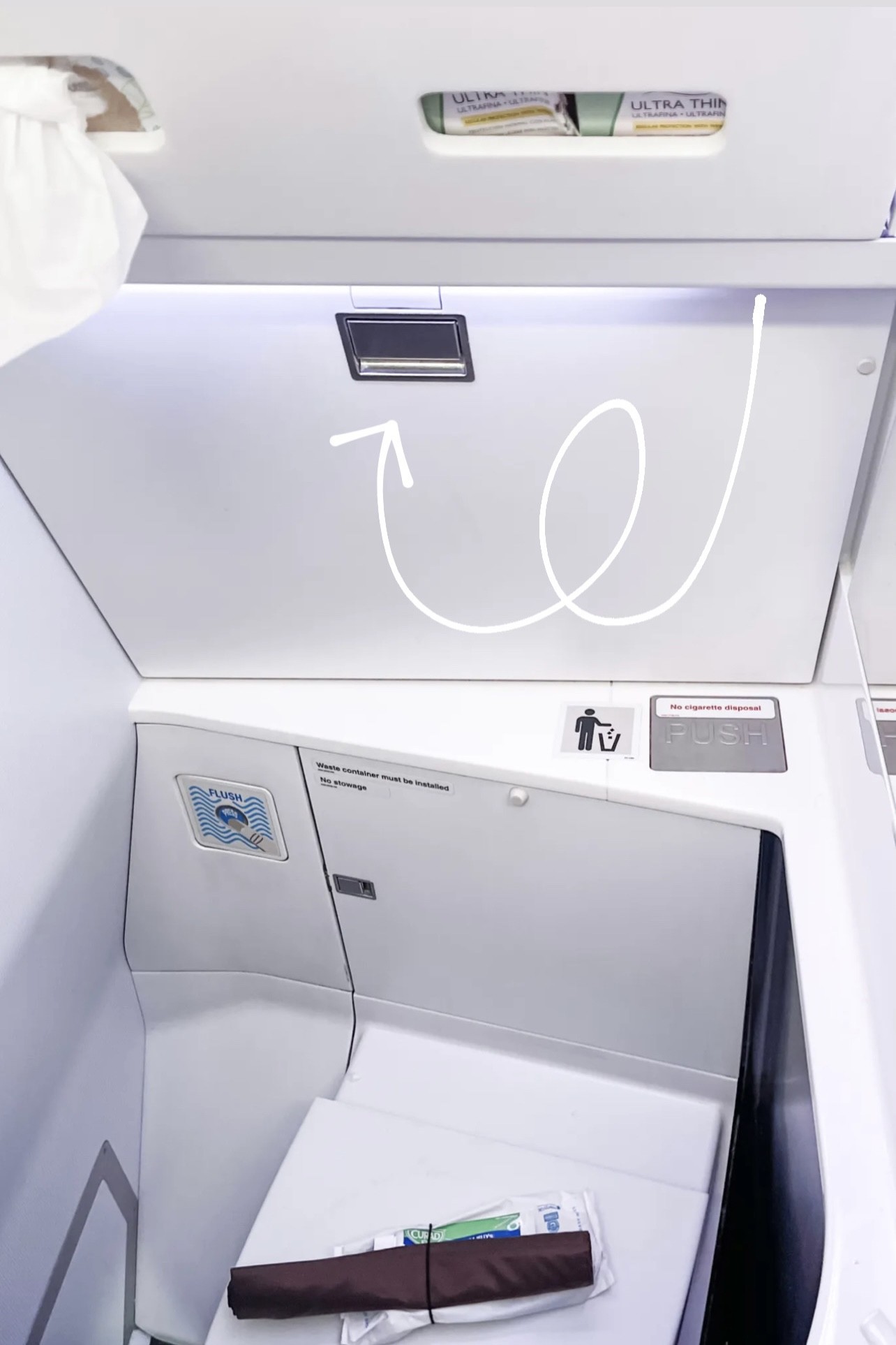 Airplane lavatory changing table, showing the compact changing facilities available on most flights.