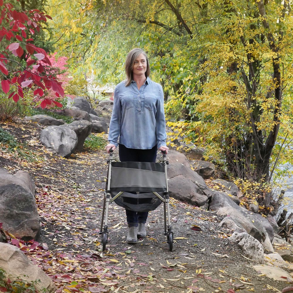 Person using Elite Travel Walker on a nature trail