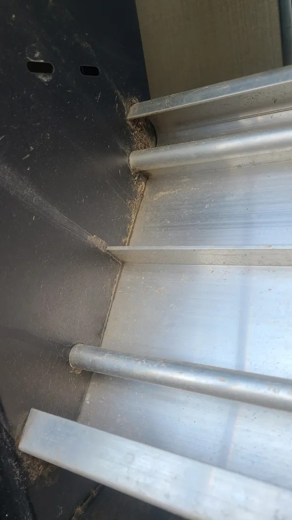 Underside view of SolidStep RV steps, showing the grooved design that traps dirt and debris