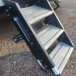 Lippert SolidStep RV steps folded and stowed inside the travel trailer entryway