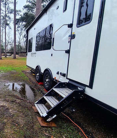 SolidStep RV steps leg sinking into mud at a campsite, requiring makeshift leveling solutions