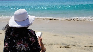 A thalassophile woman peacefully gazing at the ocean horizon in the Caribbean