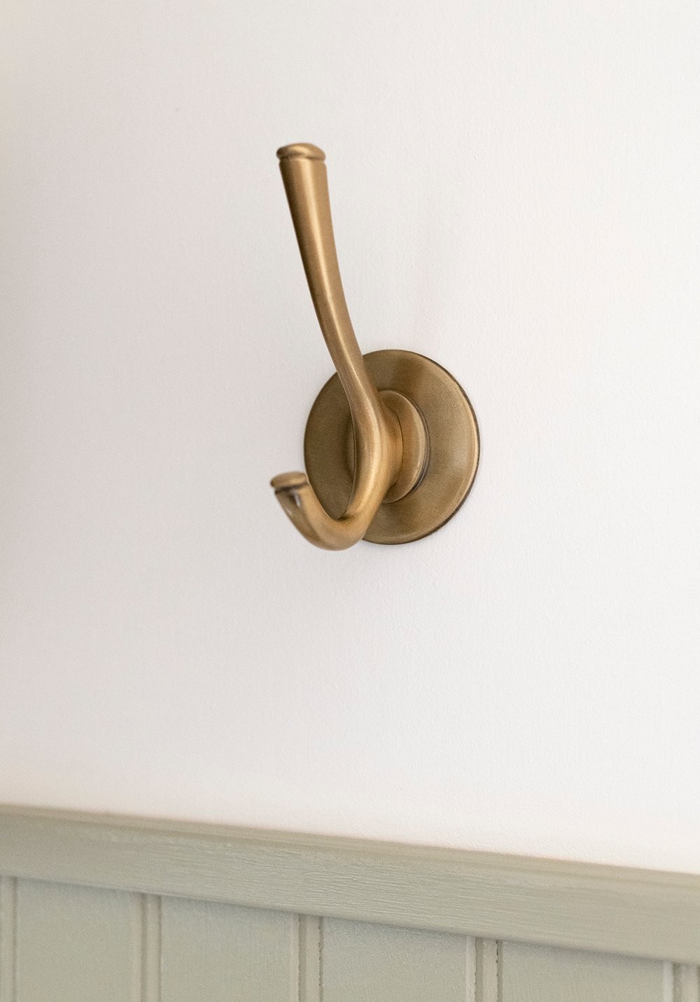 Adhesive brass hooks used in camper for versatile storage