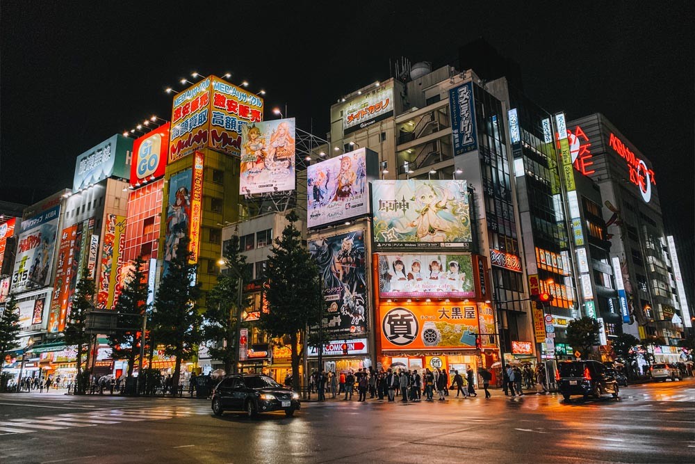 Akihabara at night, illuminated with neon lights and vibrant signs