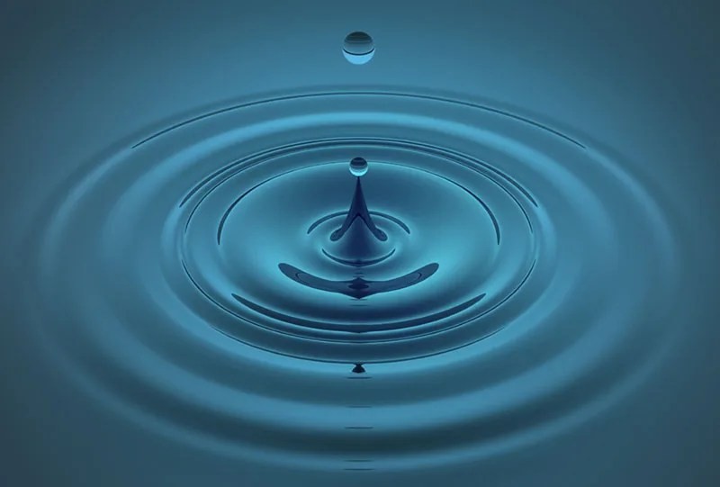 Ripples expanding on the surface of water, illustrating wave propagation.