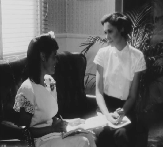 Still from Illusions (1982) showing two Black women in conversation, highlighting the film's focus on Black women's experiences in Hollywood.