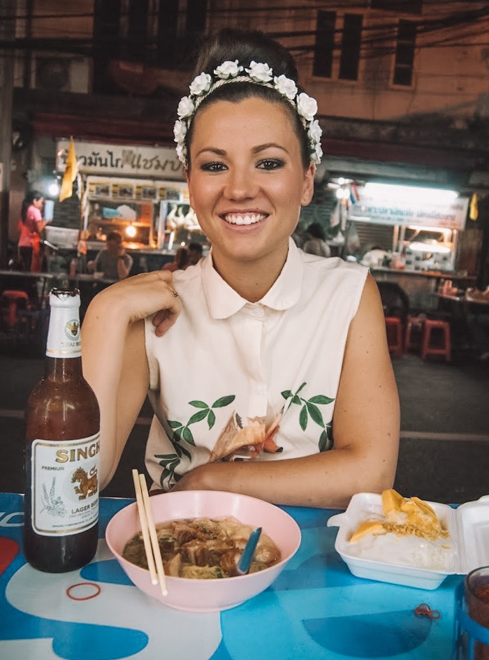 A vibrant night food market scene in Bangkok, illustrating a travel experience discovered through local blog recommendations