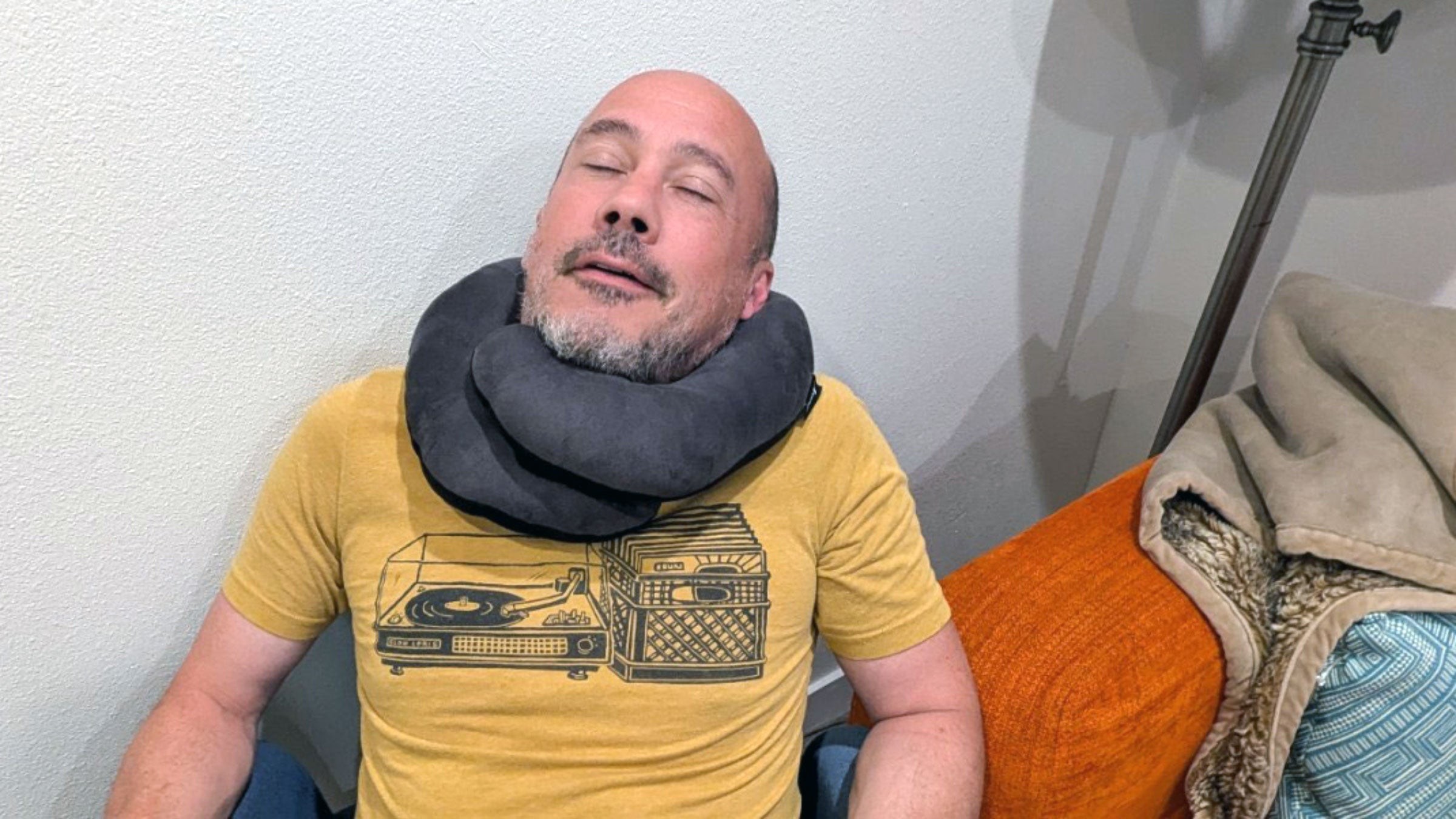 man sleeping with BCozzy neck pillow