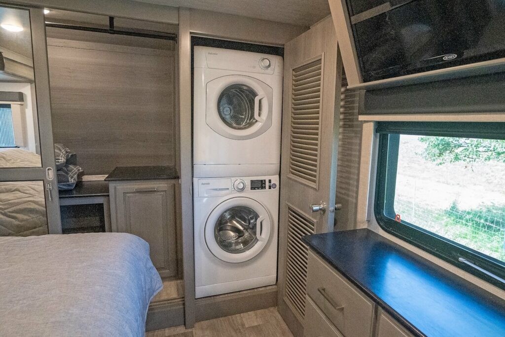 alt text: A washer and dryer unit installed in a travel trailer, highlighting the convenience of on-board laundry for RV living and travel.