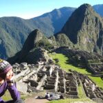 Panoramic view of Machu Picchu citadel with clear skies and surrounding mountains