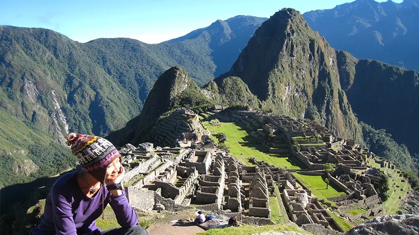 Panoramic view of Machu Picchu citadel with clear skies and surrounding mountains