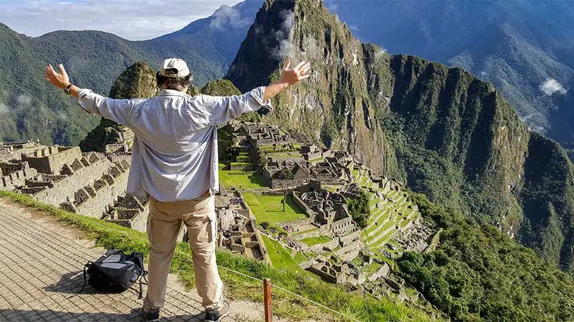 Picture of Machu Picchu in the shoulder season with a mix of sun and clouds, showcasing pleasant weather