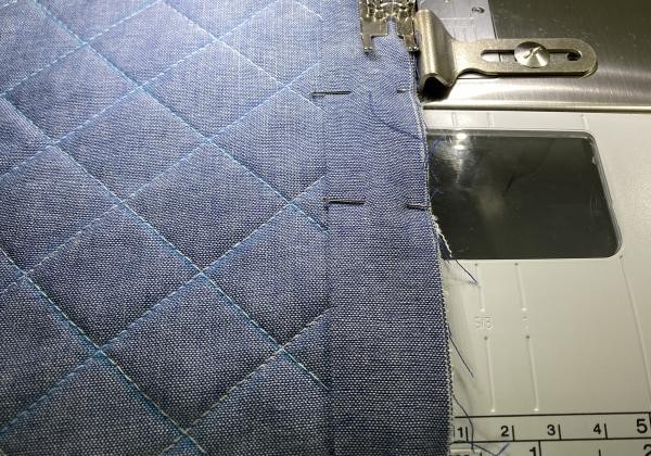 Close-up of binding being sewn around the edge of the changing pad.