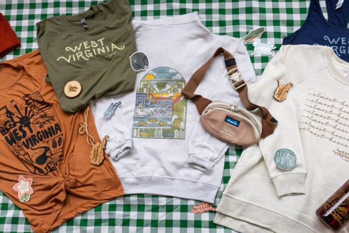 Selection of West Virginia brand merchandise including mugs and apparel