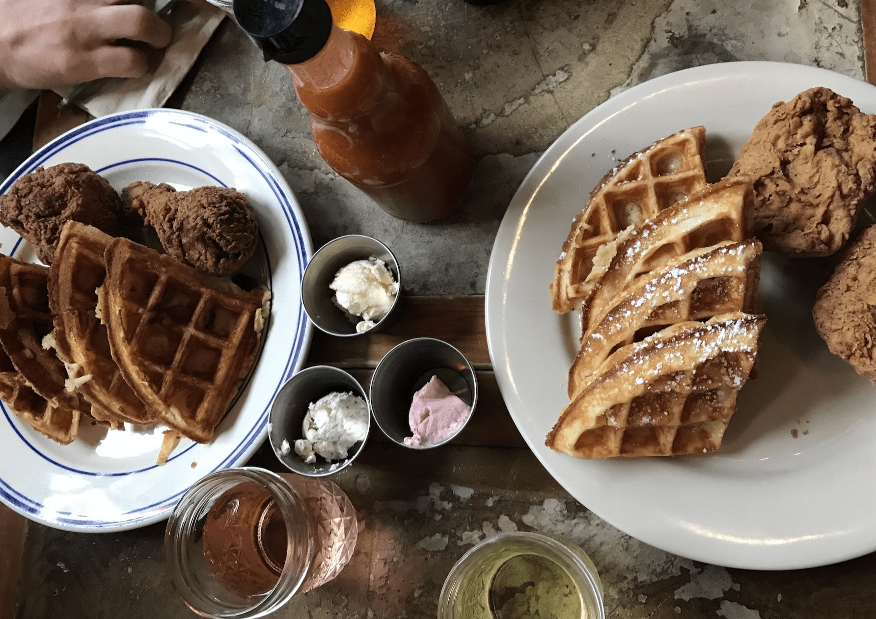 A vibrant brunch spread featuring chicken and waffles at Sweet Chick, a popular NYC restaurant.