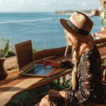 business-woman-working-with-computer-on-the-beach.-freelance-concept