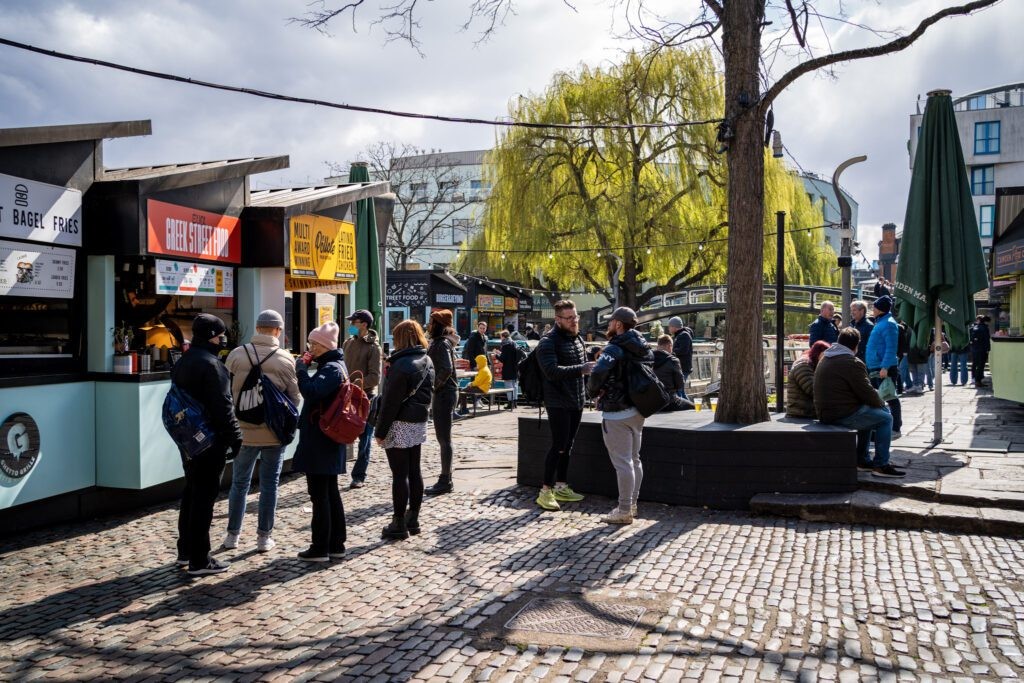 Camden Market in London, showcasing its diverse stalls, canal-side location, and bustling crowds