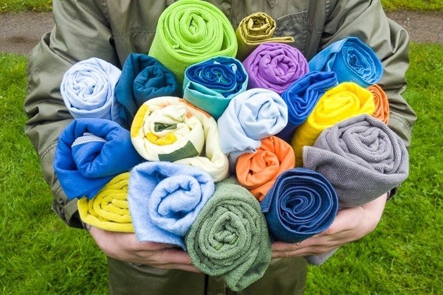 A selection of various travel towels in different materials and colors, showcasing the range of options available for travelers.