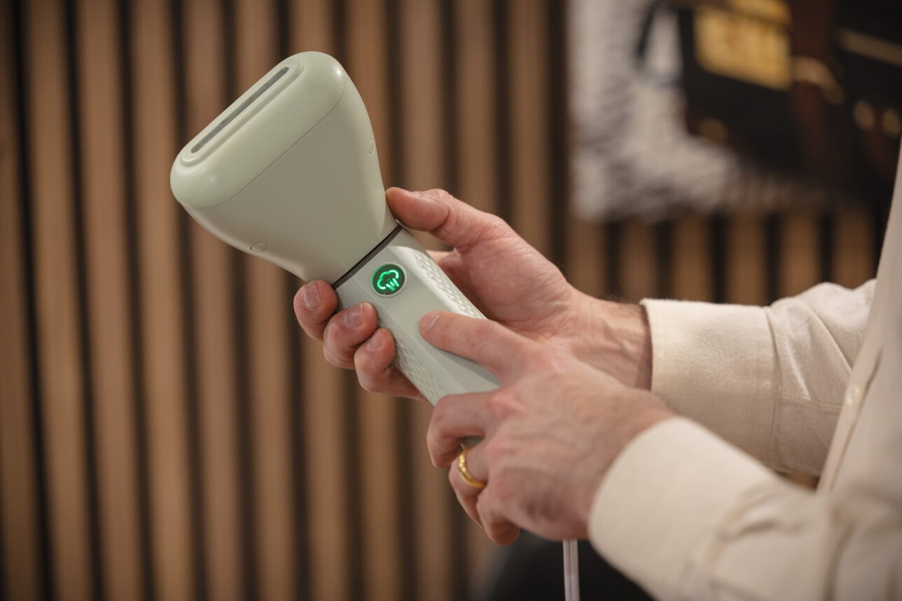 Conair Power Steam Travel Steamer in action, removing wrinkles from a garment.