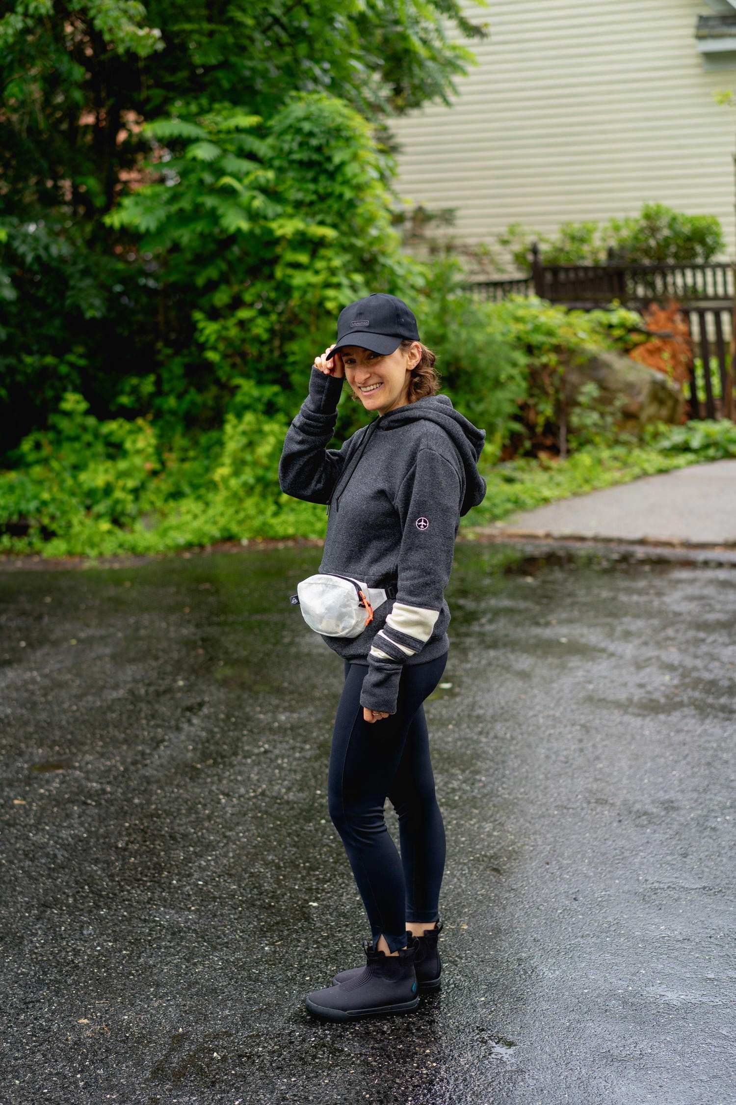 Woman packing Vessi Weekend Chelsea waterproof travel boots and other travel essentials in a suitcase.