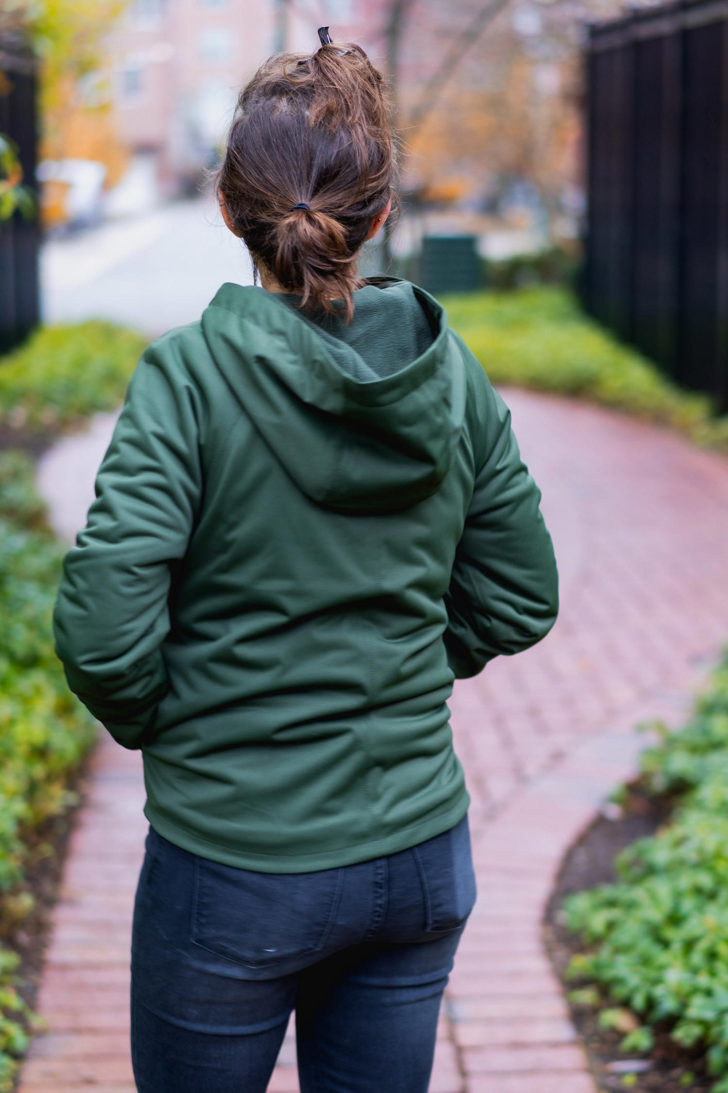 Close-up of Vessi Overcast waterproof rain jacket and Shoreline belt bag demonstrating water resistance.