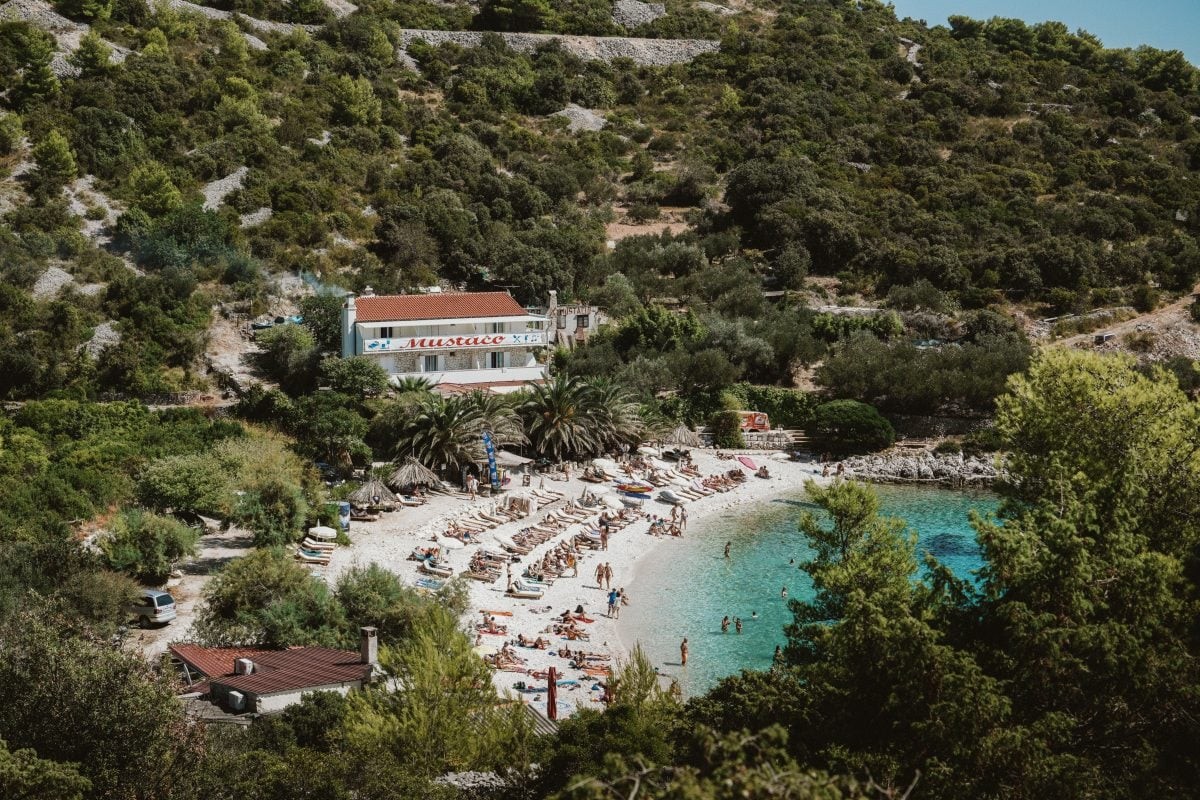 Picturesque beach on Hvar Island with turquoise waters and boats, inviting exploration and relaxation as part of a Croatia travel itinerary.