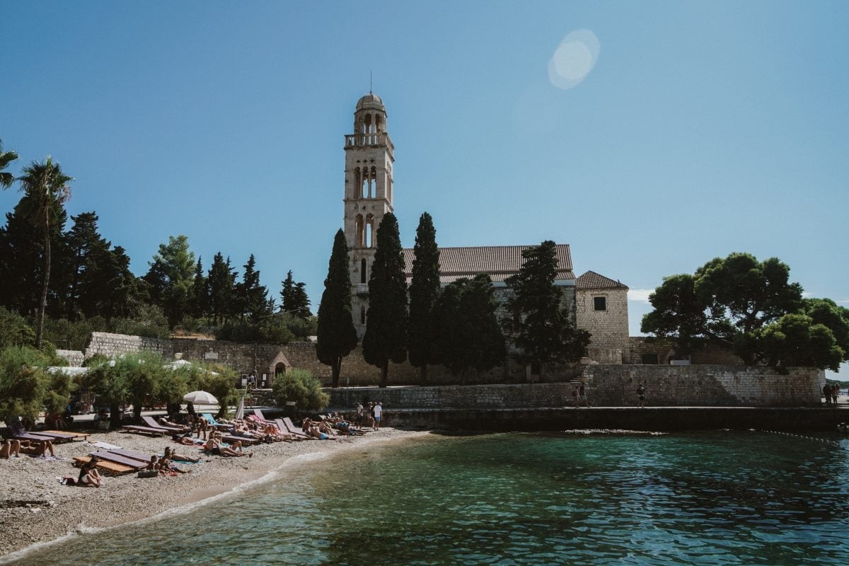 Secluded bay with crystal-clear water on Hvar Island, offering tranquility and natural beauty for a relaxing Croatia travel itinerary.