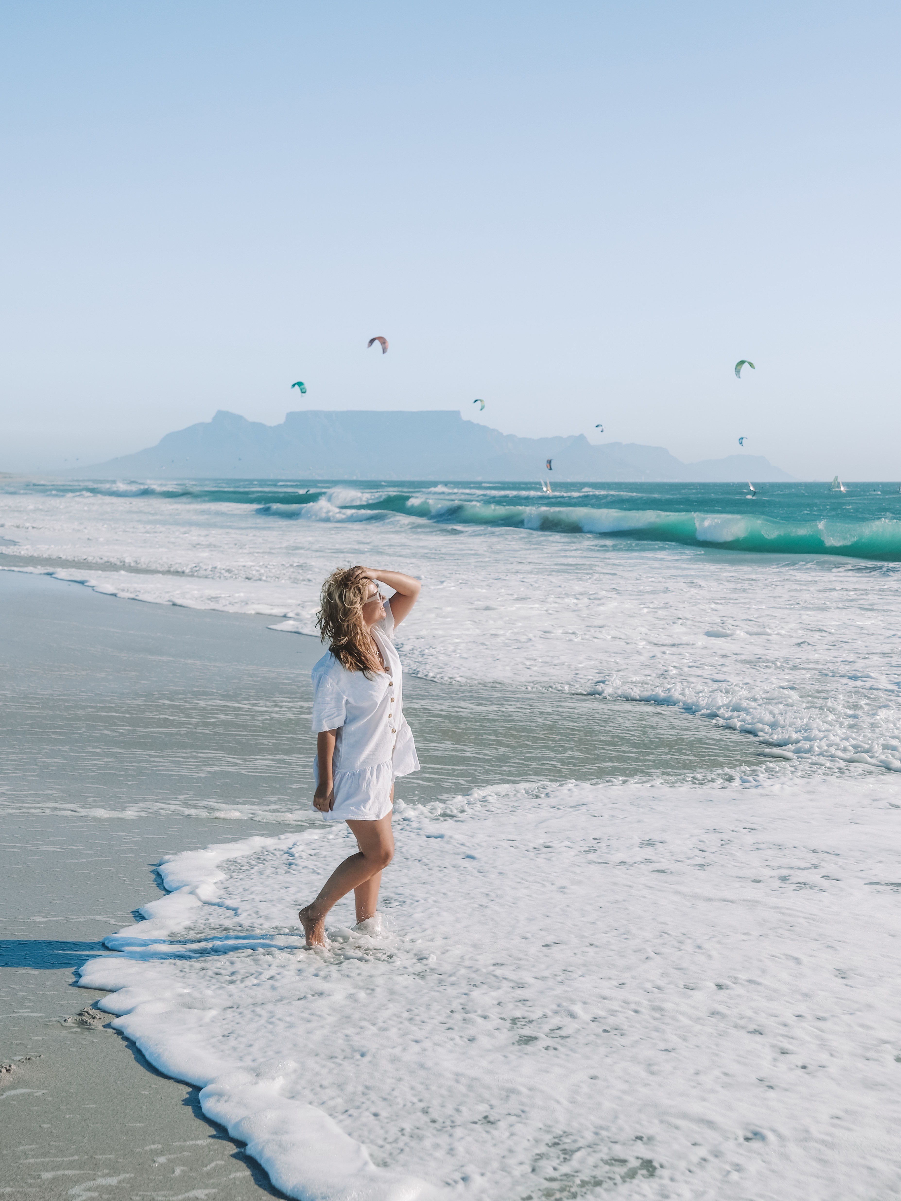 A woman looks out over a scenic view of Cape Town, highlighting the benefit of local tours for discovering hidden photo locations