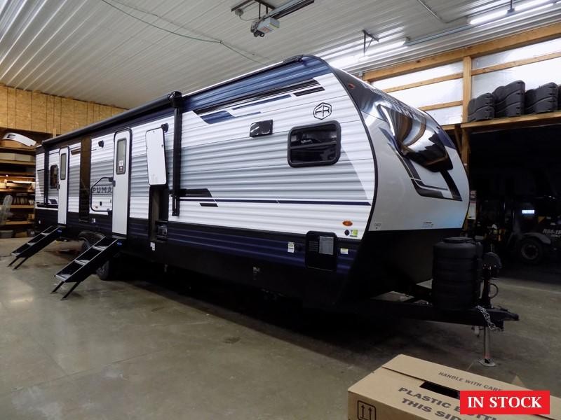 Side view of Puma 31FKRK Travel Trailer in a campsite setting