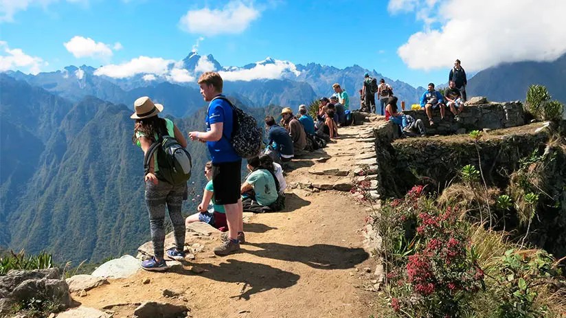 Smiling traveler enjoying the view of Machu Picchu, highlighting a positive travel experience