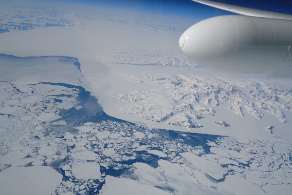 Aerial view of the vast, icy landscape of Antarctica from a plane window