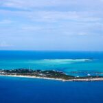 Aerial view of Exumas, Bahamas, highlighting the turquoise waters, relevant to travel and paradise imagery but contrasting with safety concerns.