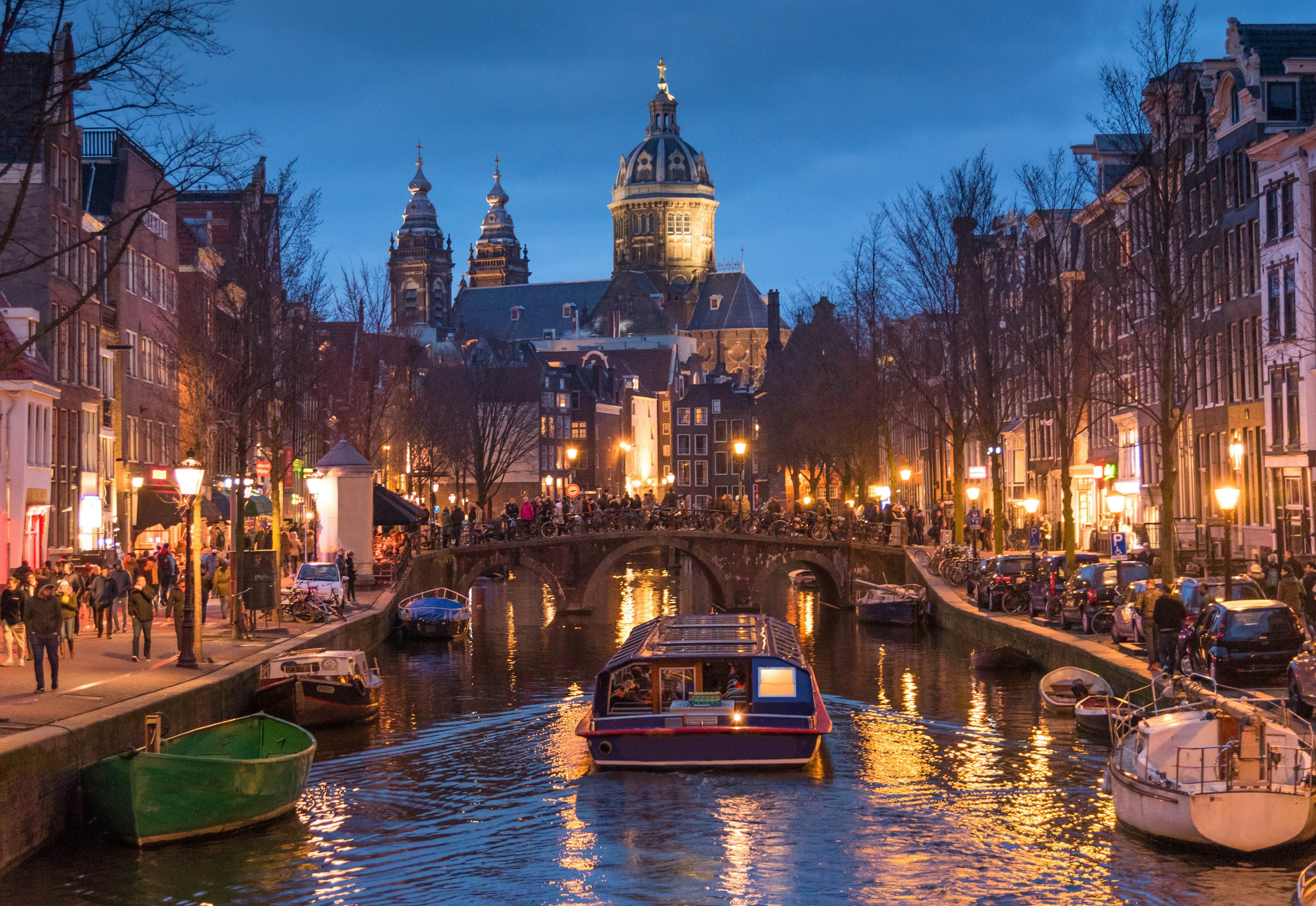 Amsterdam in the early evening, viewed from a canal bridge.