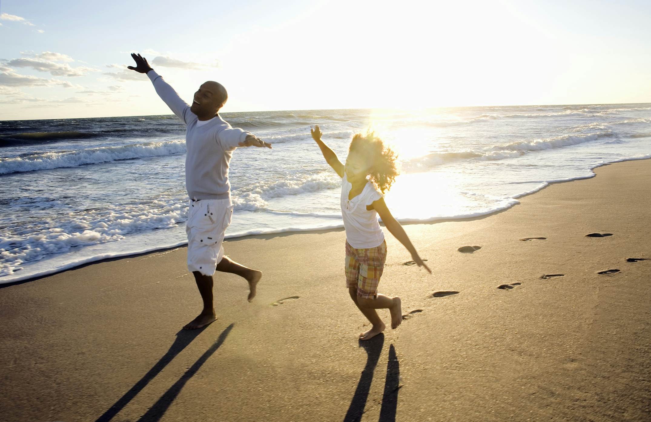 Father and daughter running on a Florida beach