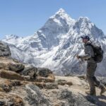 A trekker walking in a vast mountainous area