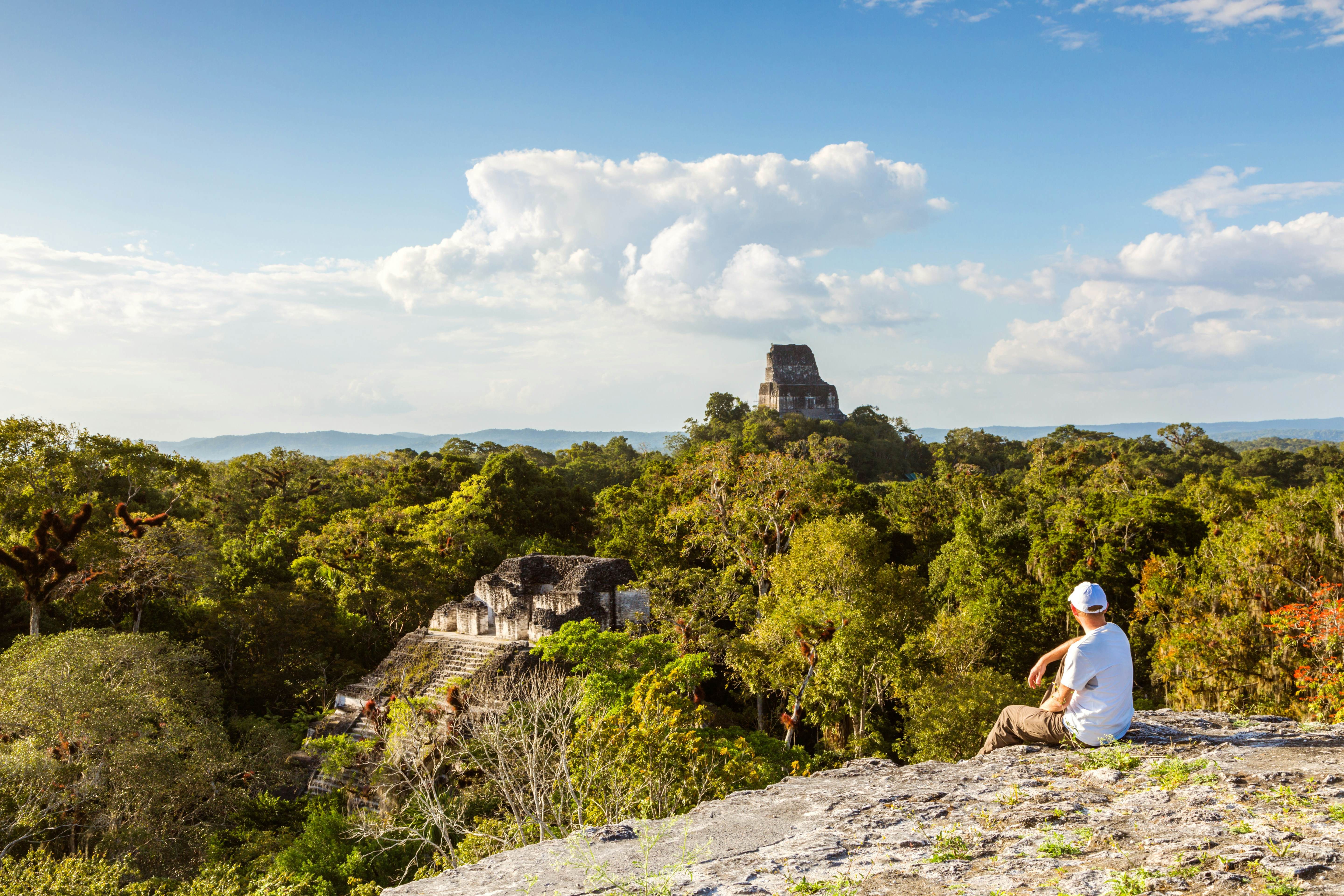 Tourist viewing Mayan ruins in Tikal