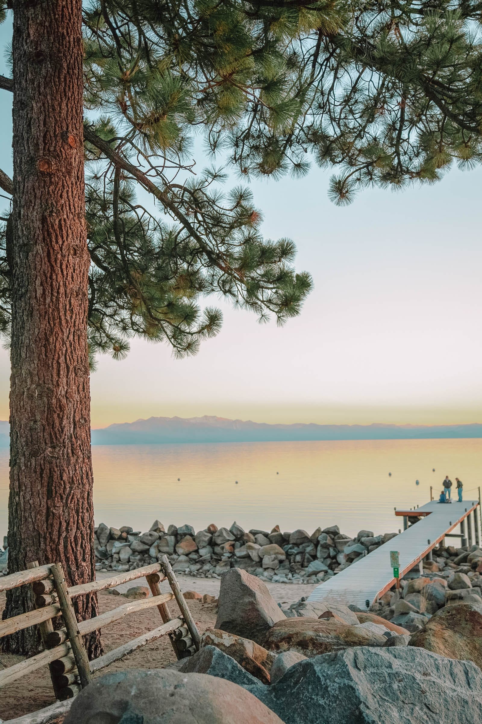 Crystal clear blue waters of Lake Tahoe surrounded by mountains, a scenic nevada travel destination